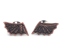 Copper Bat-shaped pin on a white background