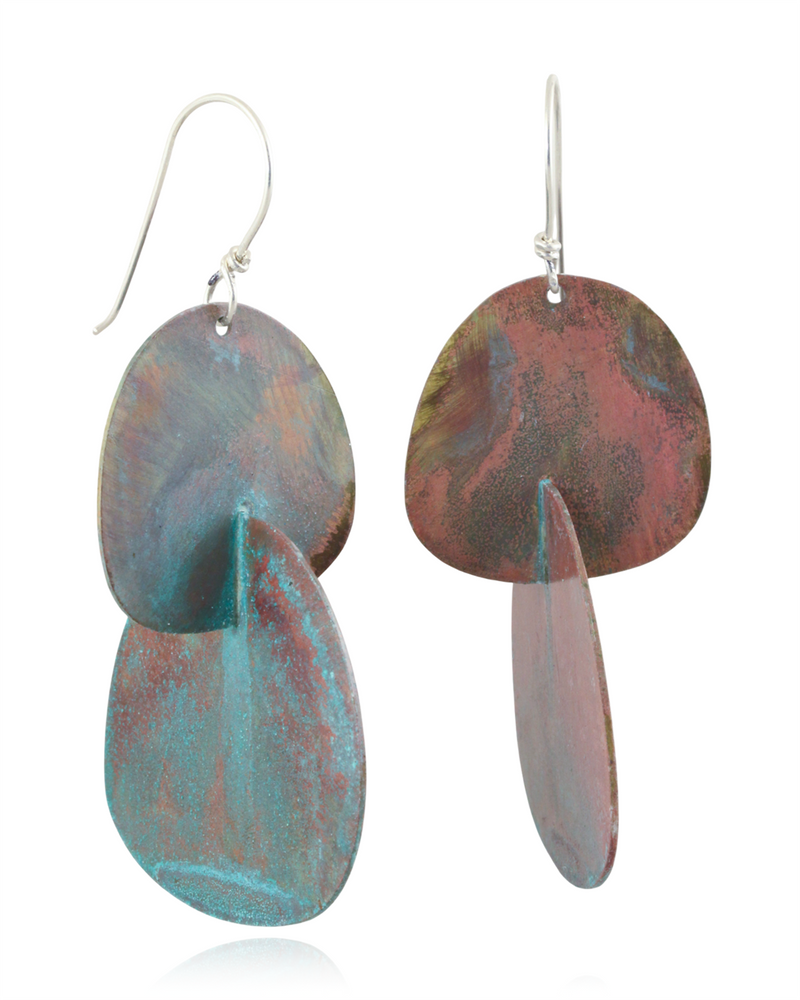 Pair of earrings with multicolored minty pink oval organic shapes on a white background.