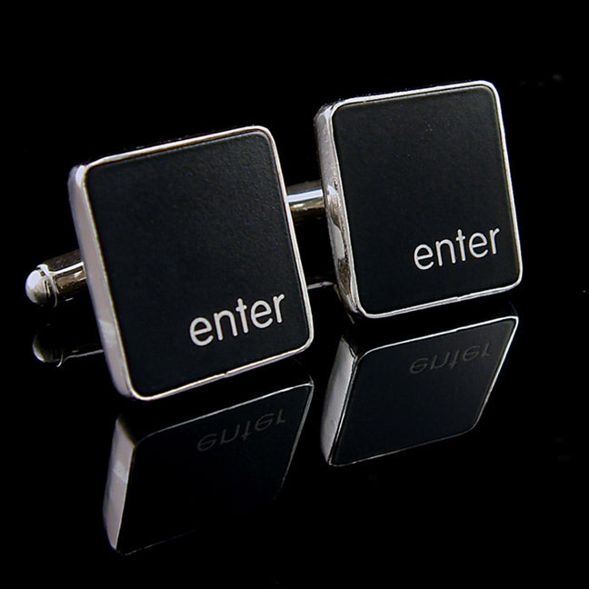Black square cufflinks with 'enter' text on a reflective black surface