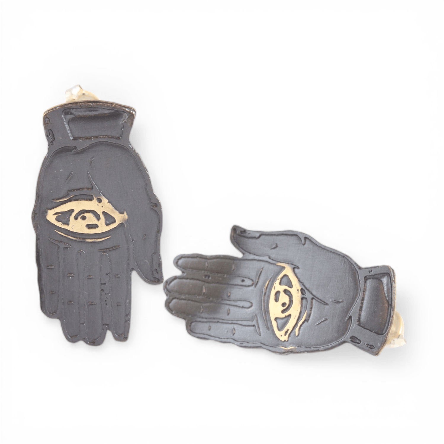 Slate colored palm with gold eye design on a white background.