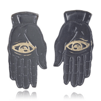 Slate colored palm with gold eye design on a white background.