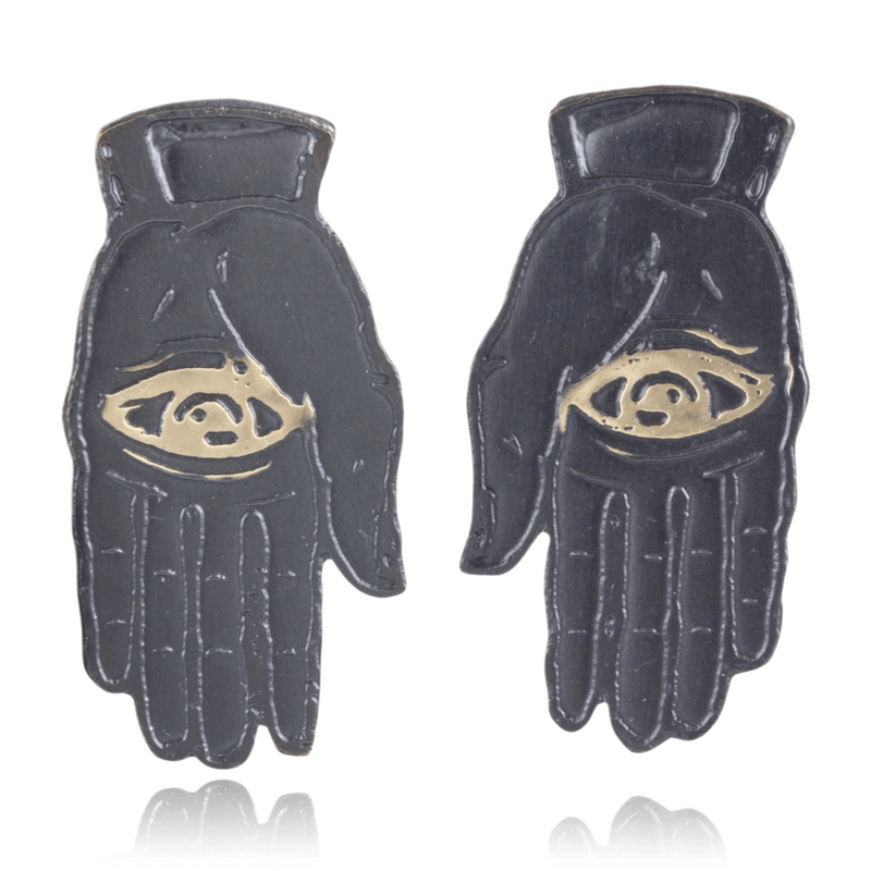 Slate colored palm with gold eye design on a white background.