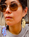 Artist modeling Torchin' Ice v1 Medium Brass  dangle earrings.