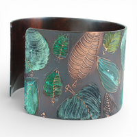 Cuff bracelet with leaf pattern on a white background