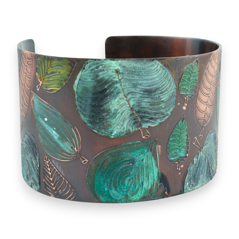 Cuff bracelet with green leaf pattern on a white background