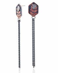 Pair of copper hexagon shaped earrings with silver skull designs and chain fringe details on a white background.