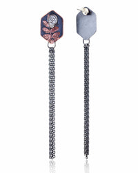 Pair of copper hexagon shaped earrings with silver skull designs and chain fringe details on a white background.