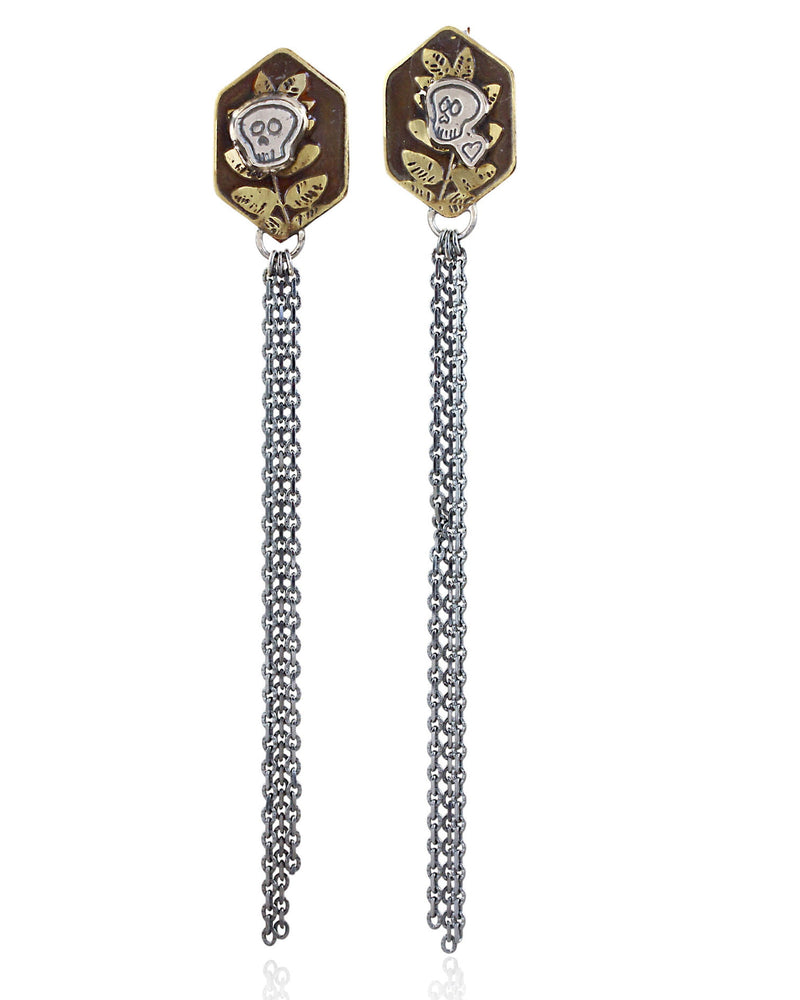 Pair of brass hexagon shaped earrings with skull designs and chain fringe details on a white background.