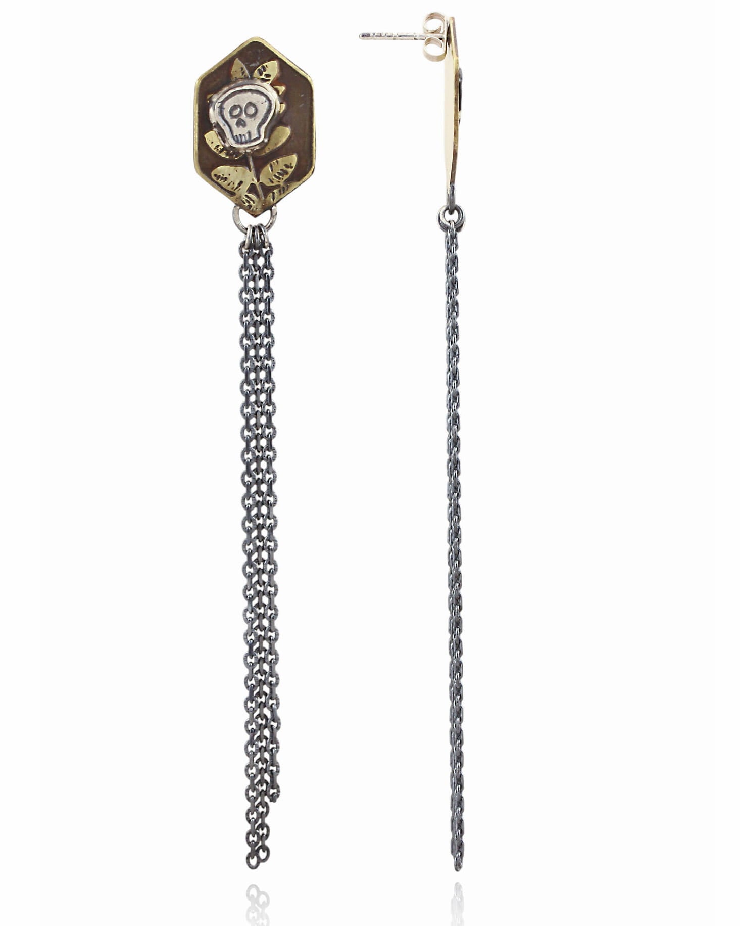 Pair of brass hexagon shaped earrings with skull designs and chain fringe details on a white background.