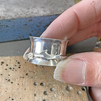 Custom Breed: Sterling silver spinner ring with dachshund running after a brass tennis ball design.