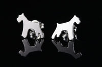 Silver dog-shaped Schnauzer breed earrings on a black background.