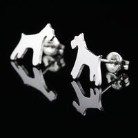 Silver dog-shaped Schnauzer breed earrings on a black background.