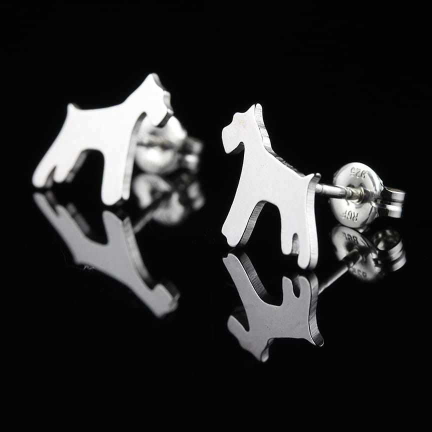 Silver dog-shaped Schnauzer breed earrings on a black background.