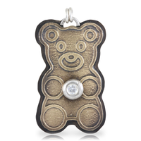 Gold teddy bear-shaped pendant with a white CZ gemstone on a white background