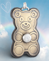 Gold teddy bear-shaped pendant with a white CZ gemstone on a rainbow background.