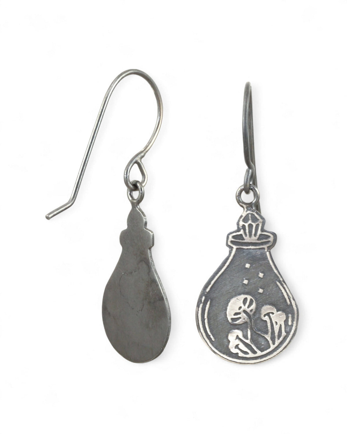 Silver earrings with a design of a potion bottle, with a crystal top, containing a mushrooms on a white background.