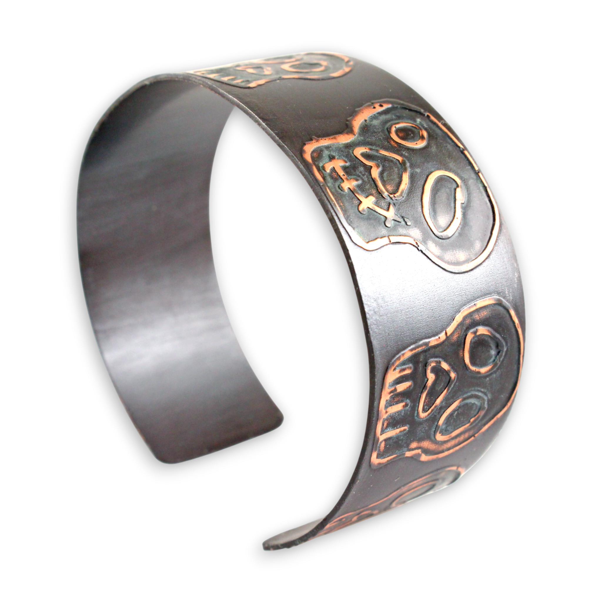 Metallic cuff bracelet with intricate blue copper skull designs on a white background