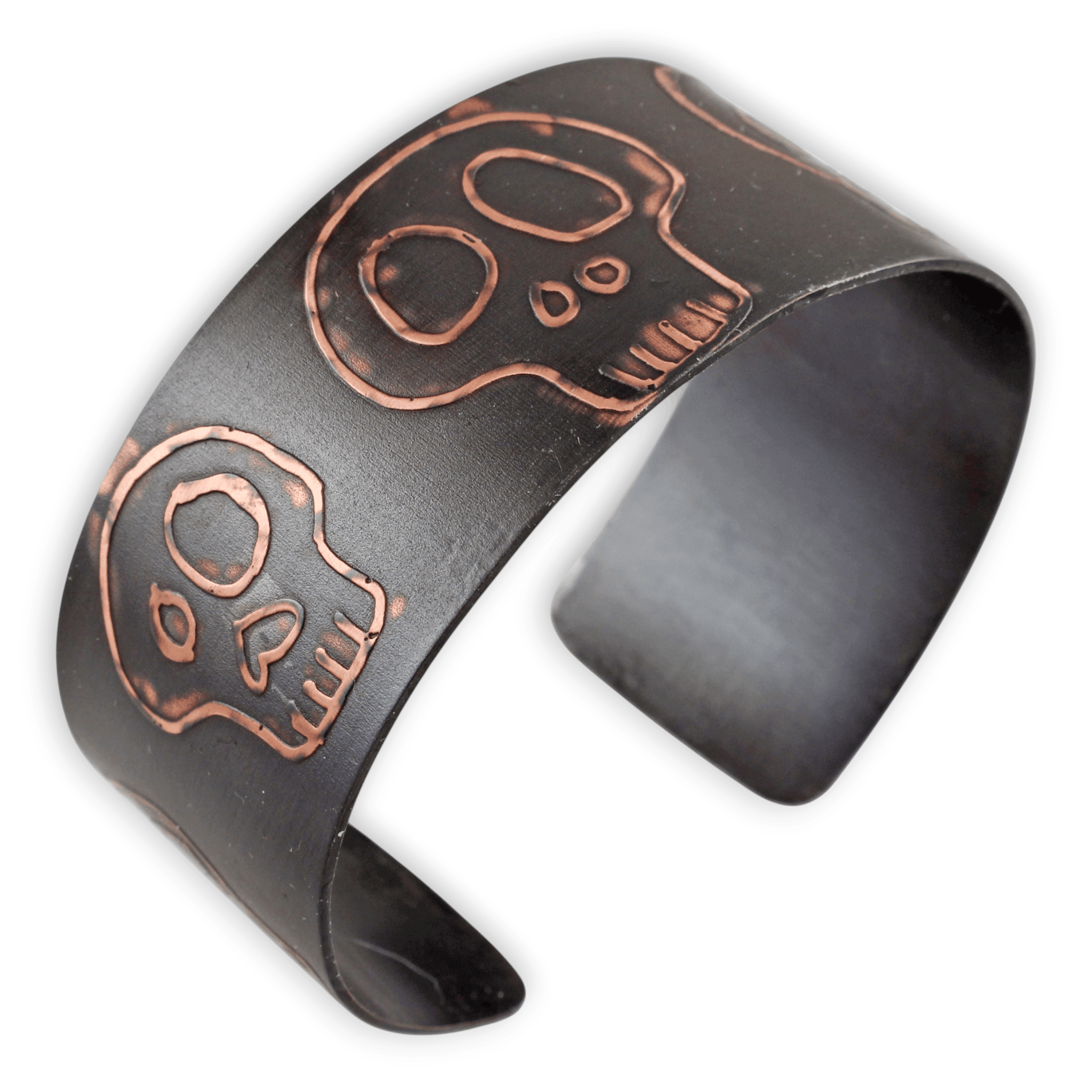 Black metal cuff bracelet with copper skull design on a white background