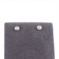 Pair of silver stud earrings on a gray felt earring pad.