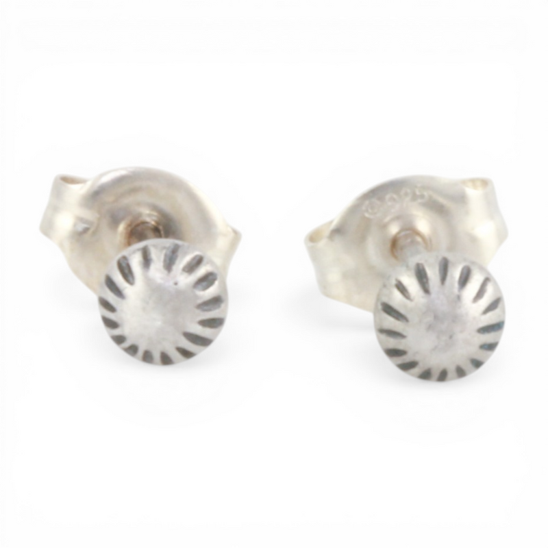 Pair of mini silver textured dot ear posts on a white background