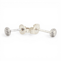 Pair of mini silver textured dot ear posts on a white background