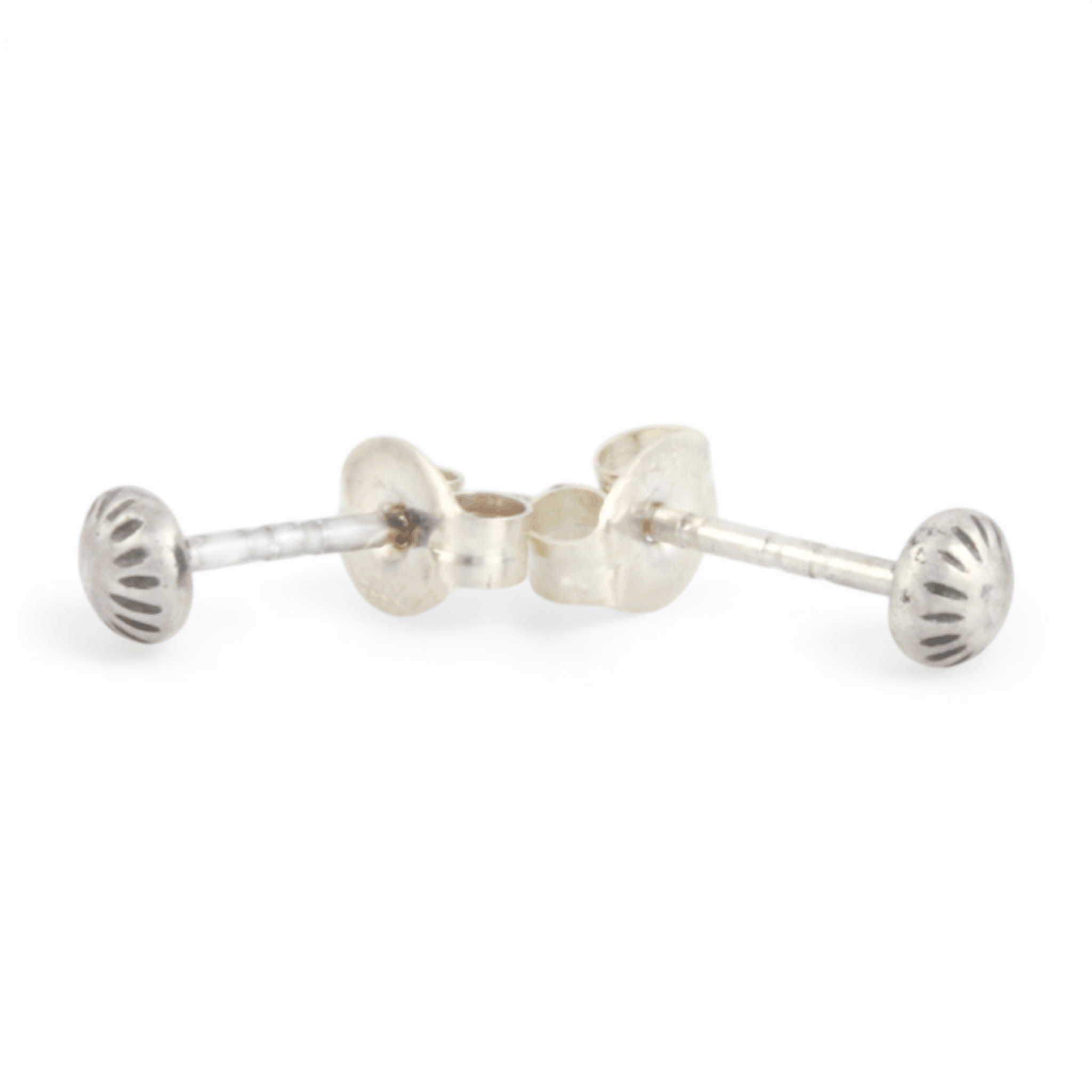 Pair of mini silver textured dot ear posts on a white background