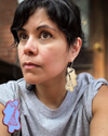 Artist modeling Torchin' Ice v1 Medium Brass  dangle earrings.