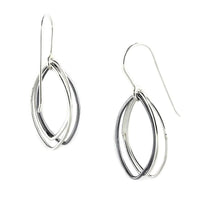 Two-toned abstract leaf dangle earrings in sterling silver, featuring oxidized and polished elements. V1