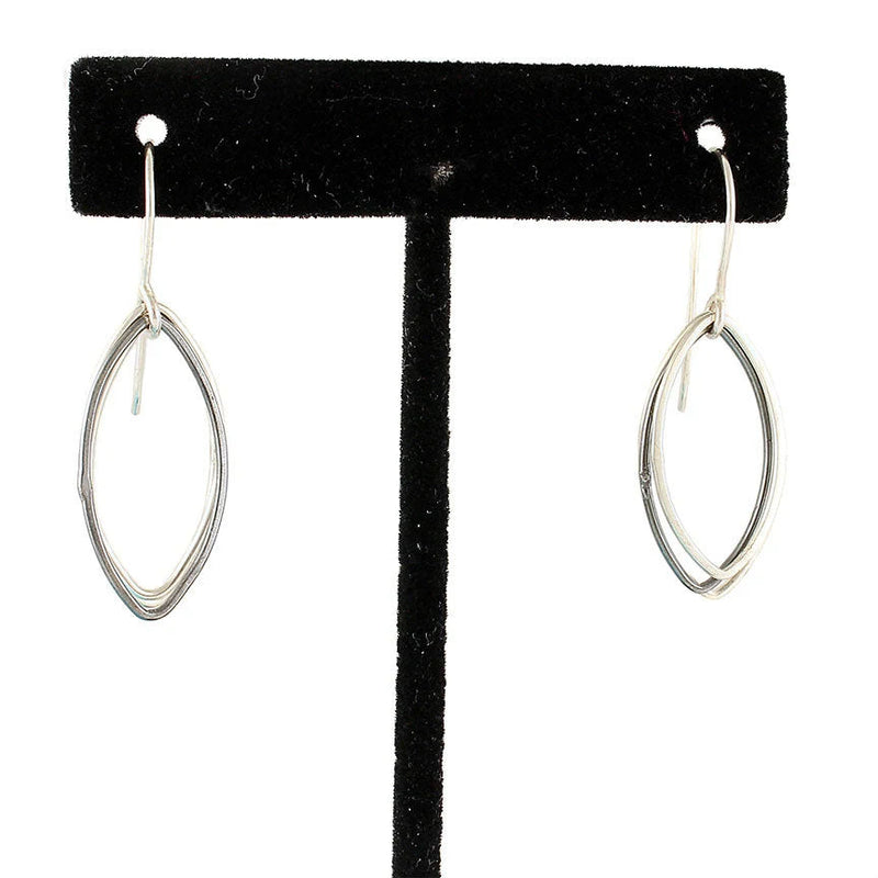 Two-toned abstract leaf dangle earrings in sterling silver, featuring oxidized and polished elements. V1