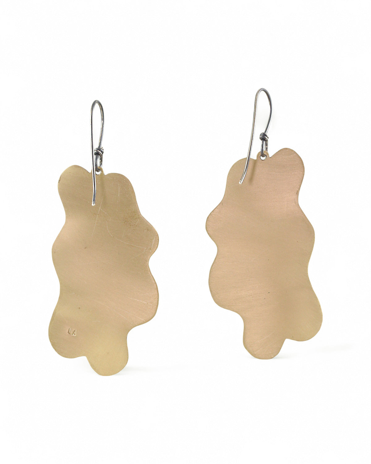 Pair of handmade and designed brass earrings with statement design on a white background. v4 Back.