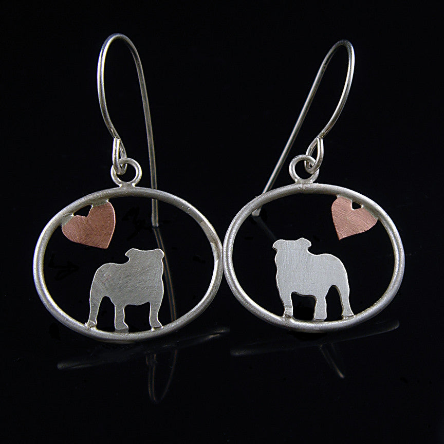 Sterling silver English Bulldog dangle earrings with copper heart inside oval frame, matte finish on black background.