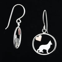 Sterling silver German Shepherd dangle earrings with a small copper heart inside oval frames, matte finish on black background.