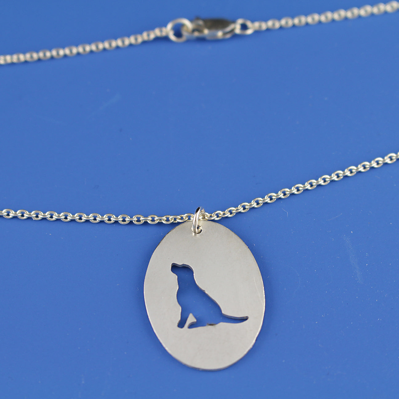 Mutt Rescue Sitting Dog Silhouette Oval Pendant