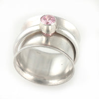 Sterling silver spinner ring with 5mm pink cubic zirconia, size 7.25 - front view