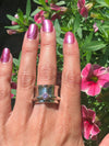 Sterling silver spinner ring with 5mm pink cubic zirconia, size 7.25 - modeled on finger
