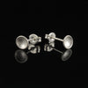 Sterling silver tiny cup studs with matte finish on black background